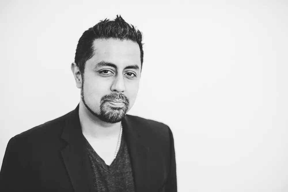 Omer Qureshi headshot — black and white editorial portrait