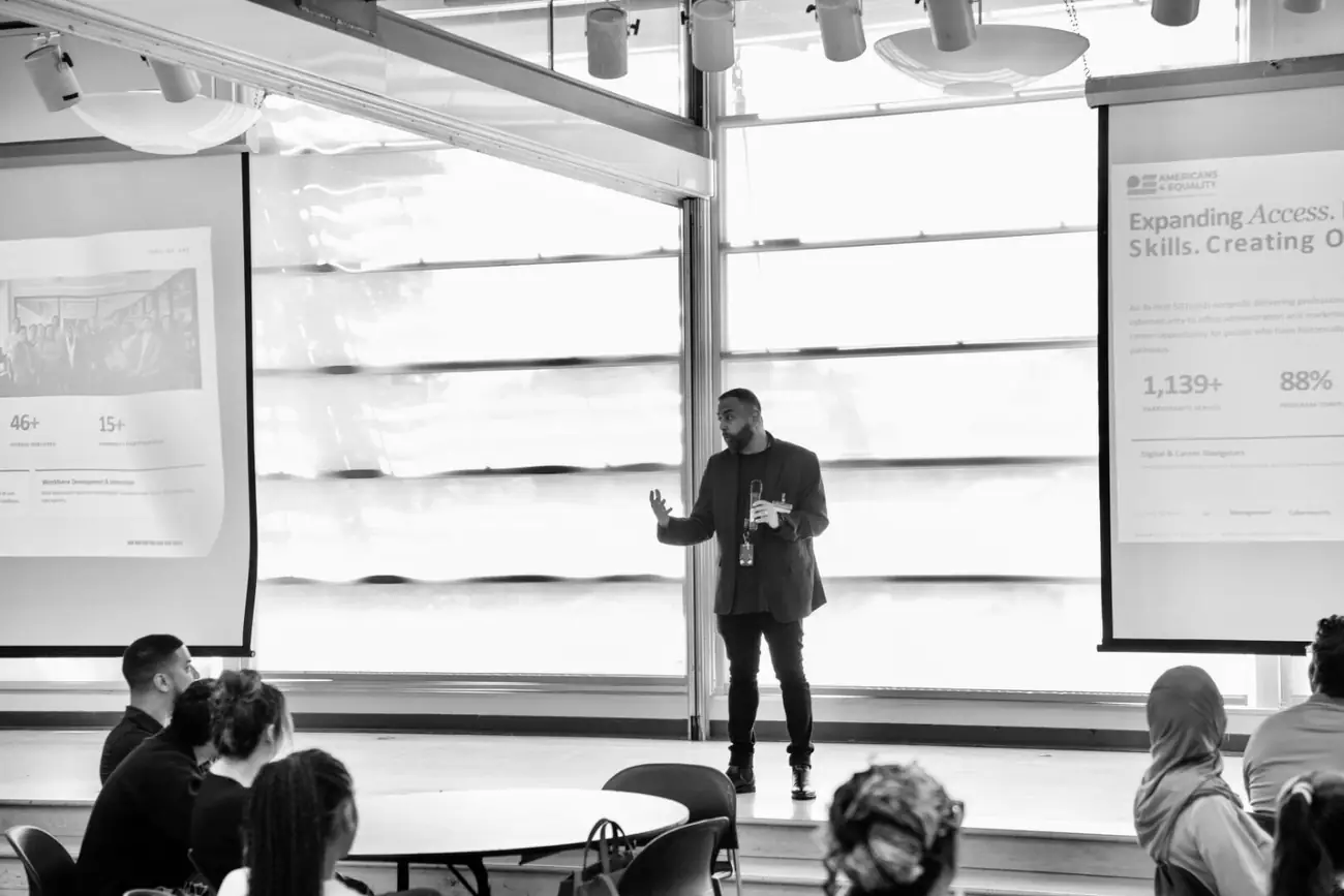 Omer Qureshi delivering a keynote in Washington DC — black and white editorial image.